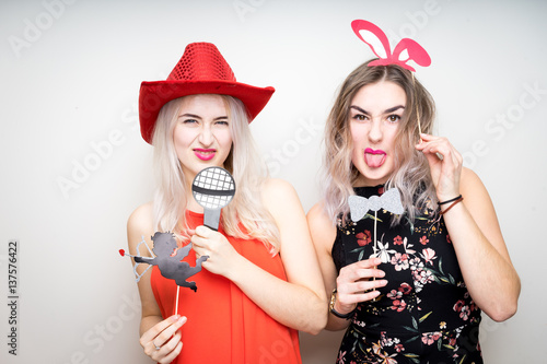 Obraz na płótnie happy ladies girls female with fancy dress photo booth props smile party white isolated background w salonie