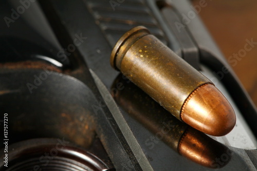 The pistol and bullet scene represent the weapon abstract concept related idea.