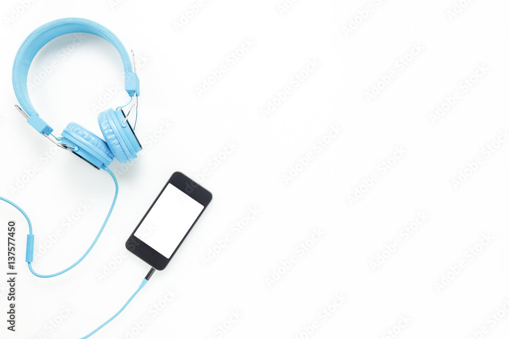 Top view accessories office desk.smartphones headphones on white background with copy space. Top view accessories office desk.smartphones headphones on white background with copy space.