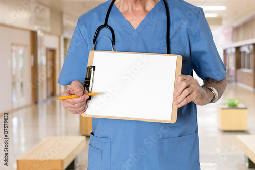 Senior doctor in scrubs with message