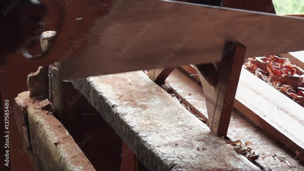 Sawing a piece of furniture - close-up shot Sawing a piece of furniture - close-up shot