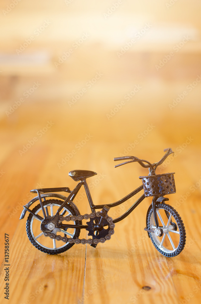 Fototapeta Small toy, bicycle model on wooden background