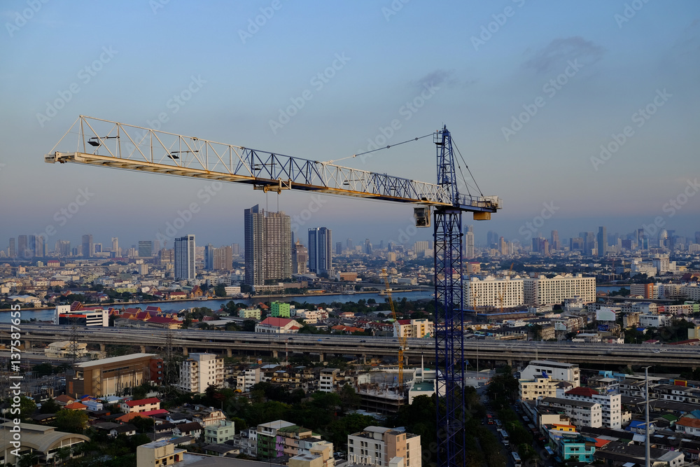 Construction tower crane with city background