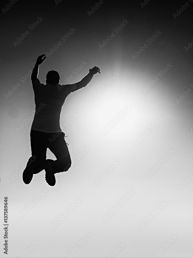 Flying man. Young man falling.  Silhouette of poise man