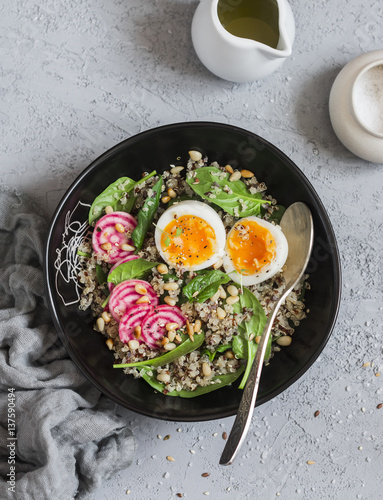 Spinach breakfast salad with quinoa, radish and egg. Healthy diet food concept. Top view