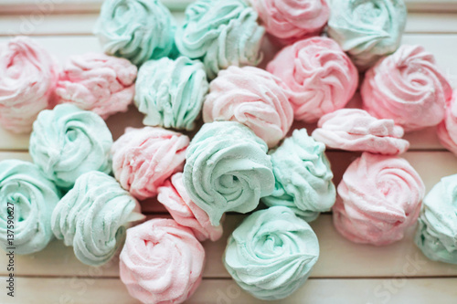 Delicious homemade marshmallow different colors on a white wooden surface. © standret
