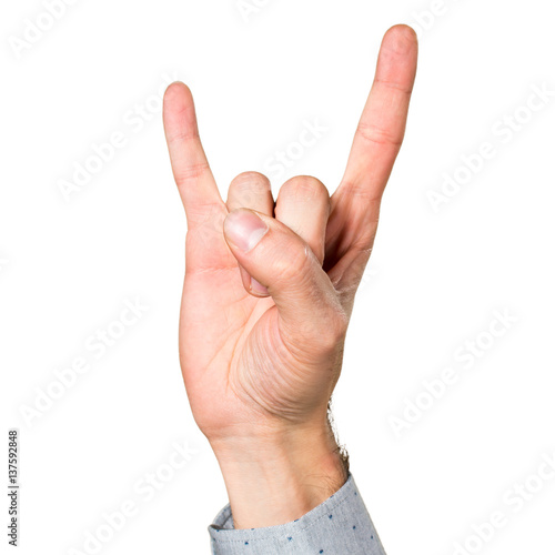 Hand of man making horn gesture