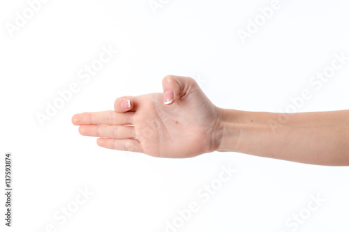 female hand outstretched to the side and showing the gesture with a bent index finger thumb is isolated on white background