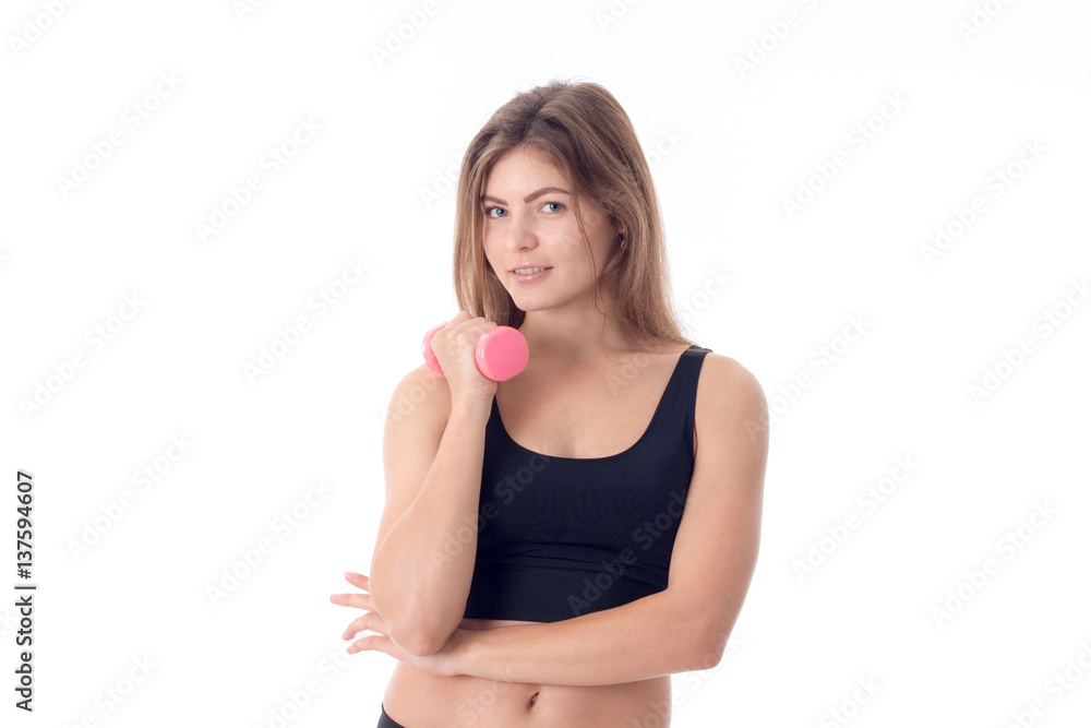 girl in black top looks ahead and holding a dumbbell is isolated on white background girl in black top looks ahead and holding a dumbbell is isolated on white background