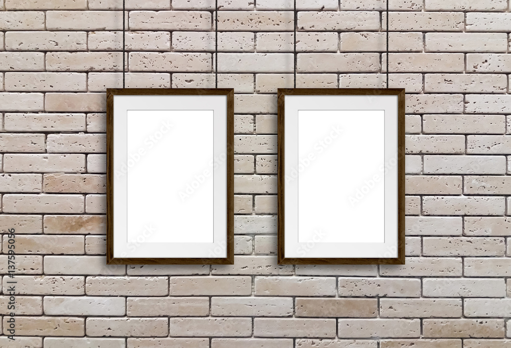 Wooden frames hanging on cords against decorative bricks wall. Gallery style, interior decor mock up Wooden frames hanging on cords against decorative bricks wall. Gallery style, interior decor mock up