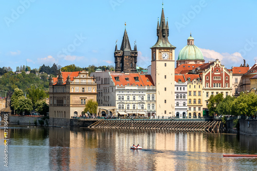 View of the church clock in Prague with the Vltava river in front