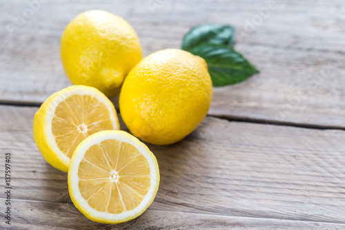 Fresh lemons on the wooden background