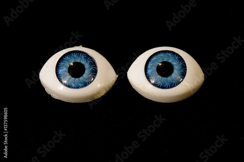 Detached Dolly Eyes With Blue Iris on Black Background