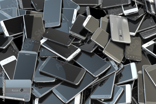 Heap of different smartphones. Mobile phone technology concept background. photo