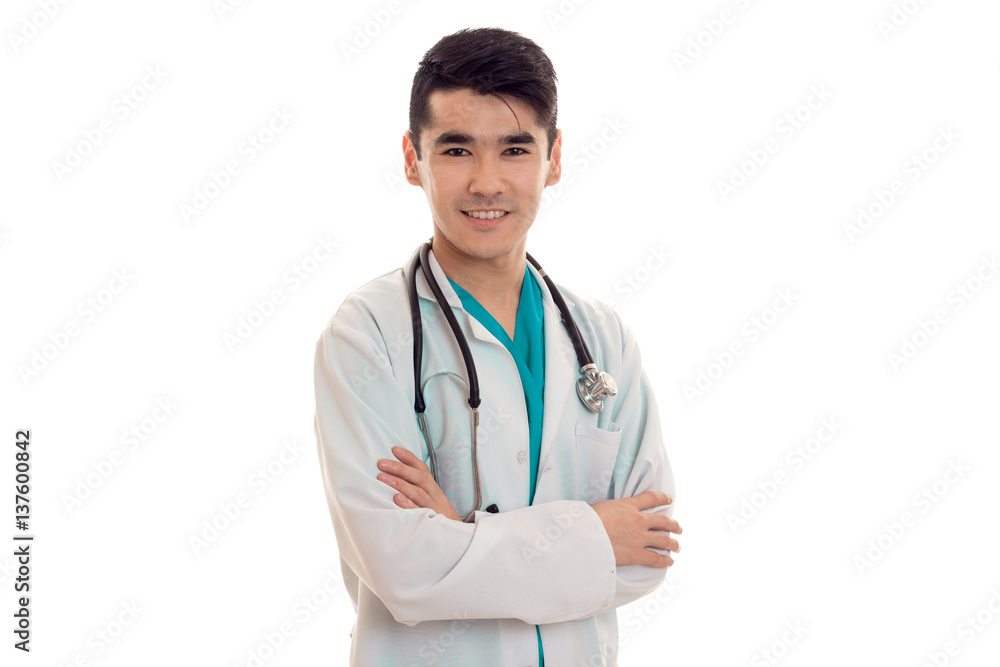 portrait of young handsome brunette man doctor in white uniform with stethoscope looking at the camera and smiling isolated on empty background portrait of young handsome brunette man doctor in white uniform with stethoscope looking at the camera and smiling isolated on empty background