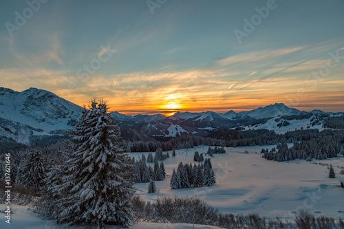 Vibrant sunset over a white snowy mountain range