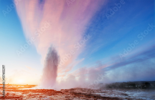 Strokkur geyser eruption in Iceland. Fantastic colors shine thro