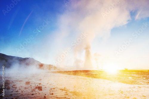 Fantastic sunset Strokkur geyser eruption in Icelan photo