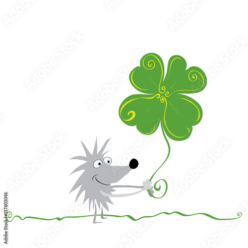 most successful day  cheerful hedgehog with four-leaf clover is walking across the lawn