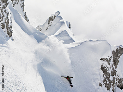 Snowboarder speeding downhill, Innsbruck, Tyrol, Austria photo