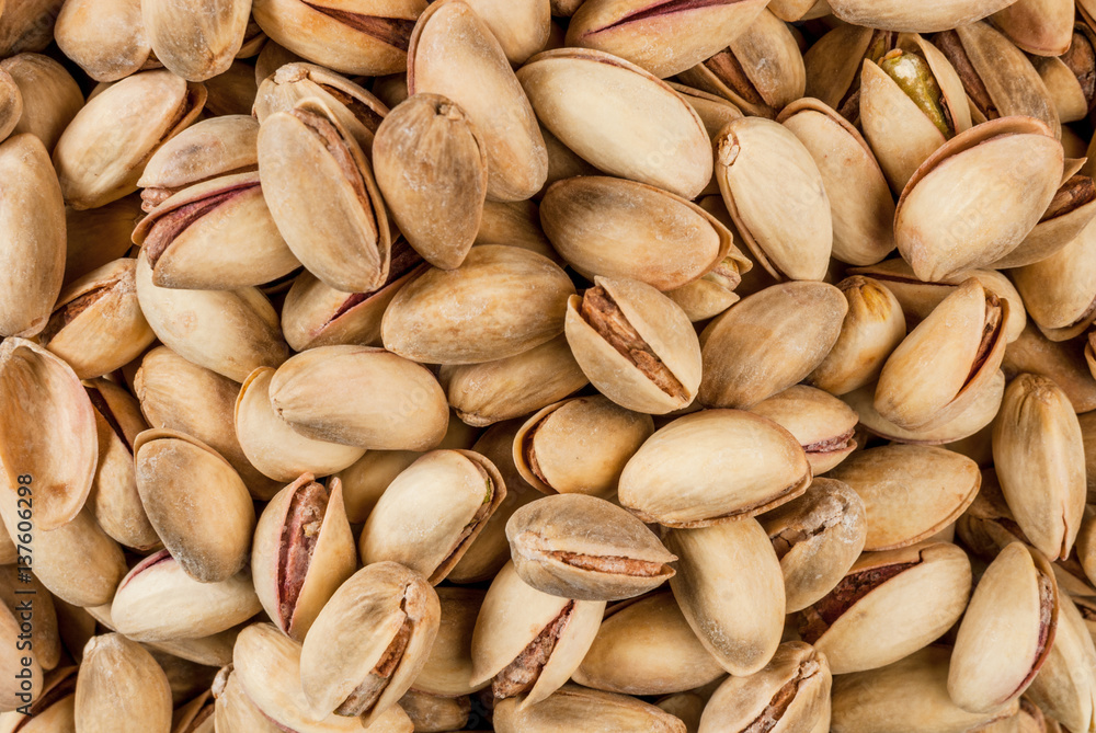 Pistachio nuts in a wooden bowl close view