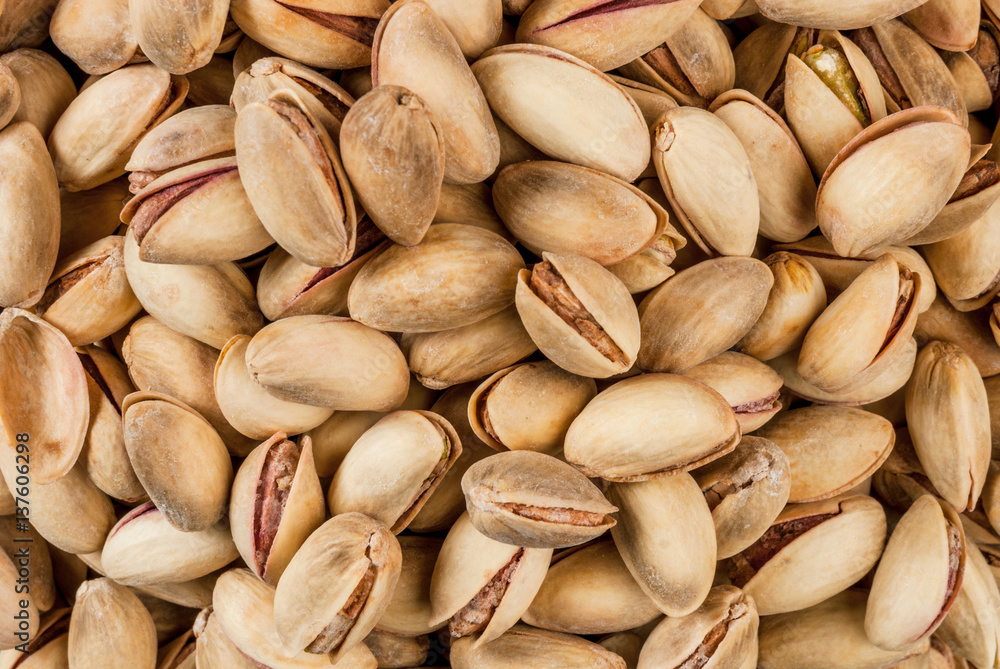 Pistachio nuts in a wooden bowl close view Pistachio nuts in a wooden bowl close view