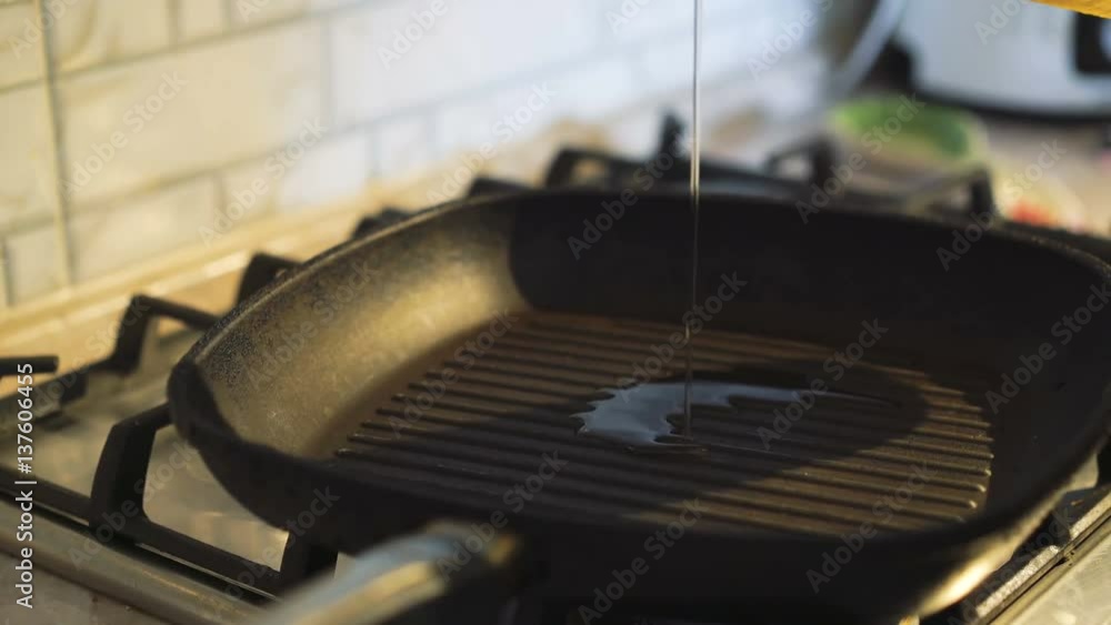 Pouring oil into frying pan in 4K Pouring oil into frying pan in 4K