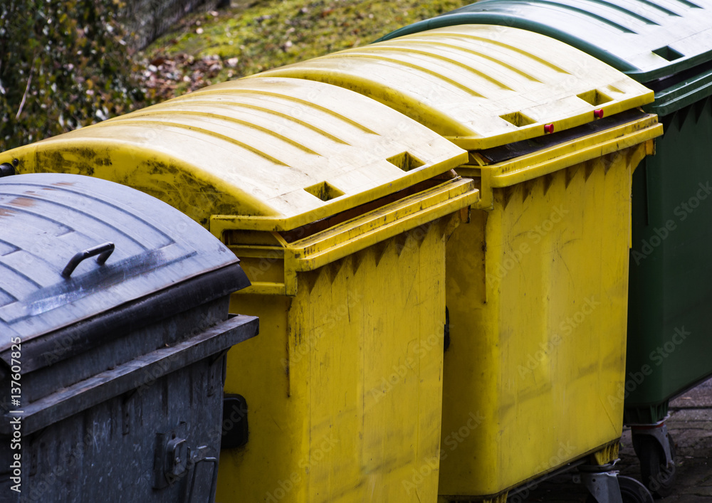 Row of garbage cans for waste separation Row of garbage cans for waste separation