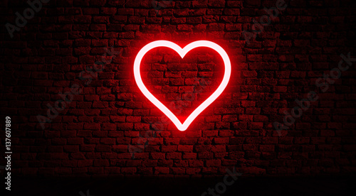 Neon heart on brick wall