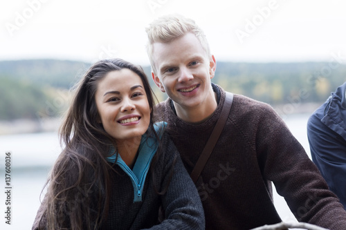 Smiling Multiethnic Couple At Lakeside Camping