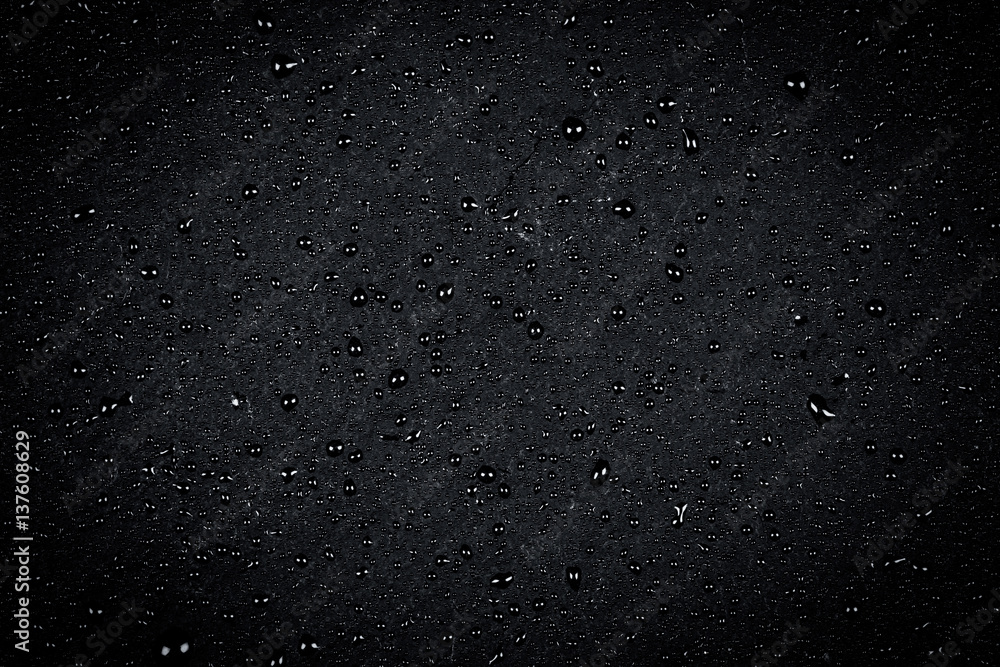 Water drops on dark stone Water drops on dark stone