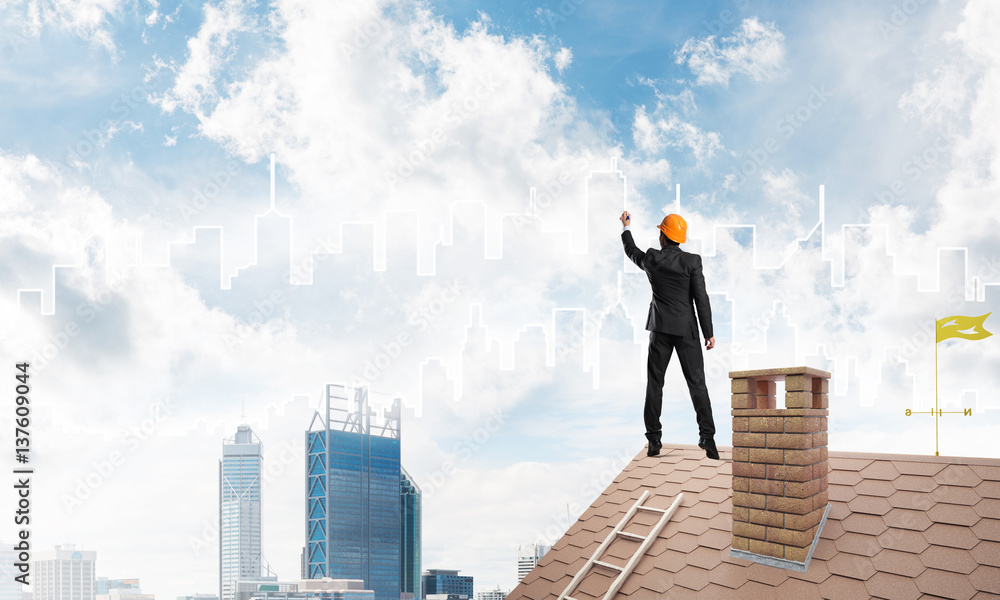 Man architect draw silhouette of modern city on blue sky. Mixed media Man architect draw silhouette of modern city on blue sky. Mixed media