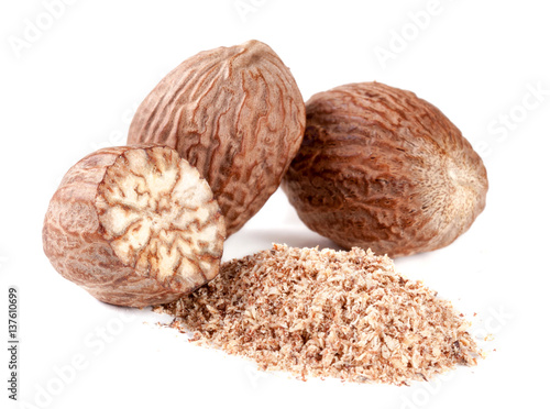Three nutmeg and powder isolated on white background