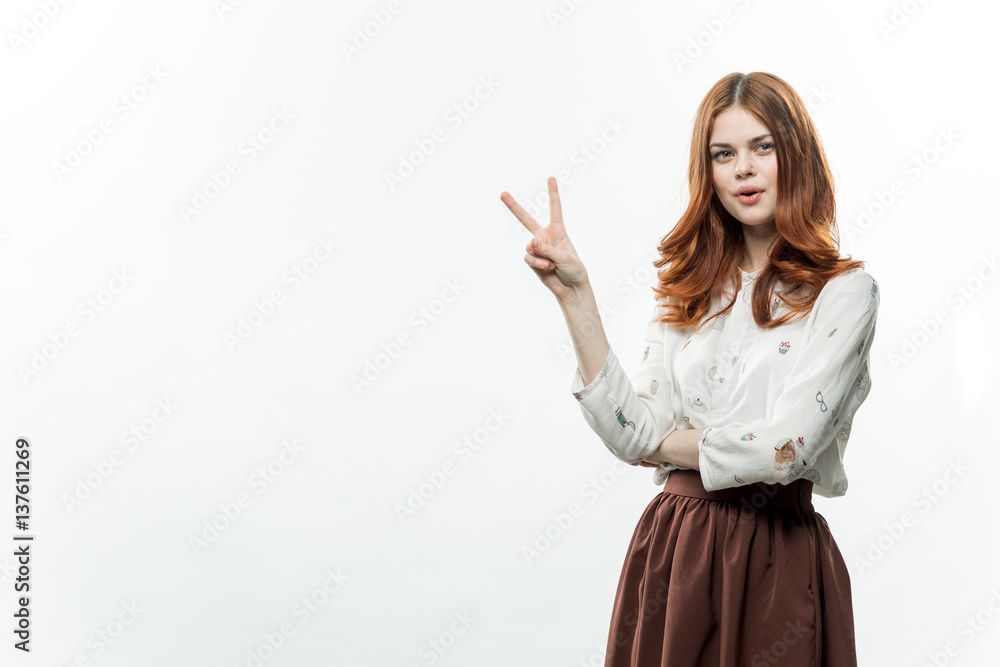 fashionable woman in a shirt and in a skirt gestures with her hands fashionable woman in a shirt and in a skirt gestures with her hands