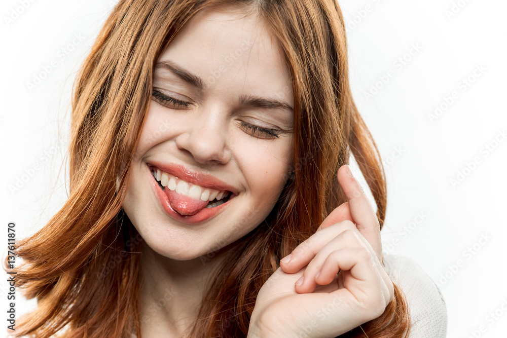 Fototapeta premium cheerful red-haired woman shows tongue