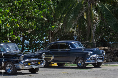 Fototapeta Naklejka Na Ścianę i Meble -  Zwei schwarze Oldtimer parken am Strand von Varadero Kuba - Serie Kuba Reportage