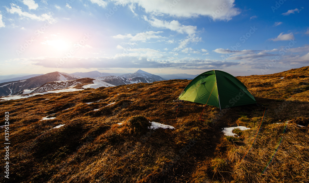 The tent is made up of green in the Carpathians. Spring mountain