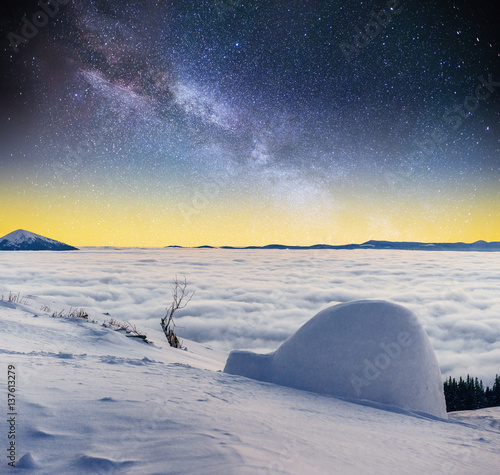 Starry sky and the Milky Way  a yurt in winter fog mountains © standret