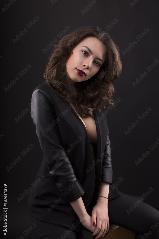 Stunning young woman with decollete and leather jacket Stunning young woman with decollete and leather jacket