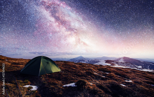 the starry sky above the tent in the mountains. Magic event in f photo