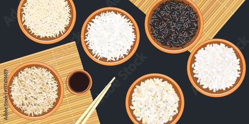 Different types of rice in ceramic bowls. Basmati, wild, jasmine, long brown, arborio, sushi. chopsticks. Kitchen bamboo mat