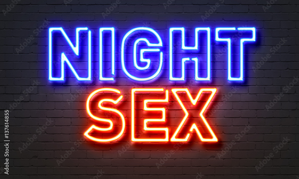 Night sex neon sign on brick wall background.