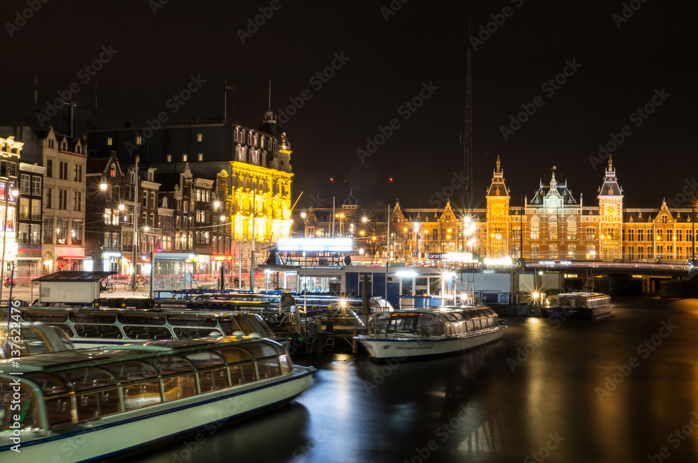 Cityscape of Amsterdam in the Netherlands by night with the central station