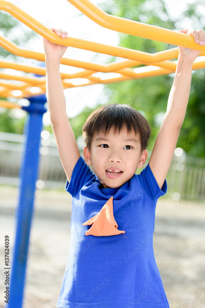 Fototapeta premium Young boy play with yellow bar