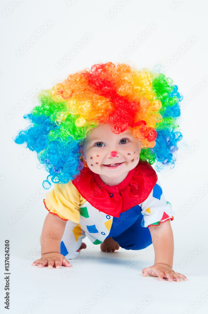 Child clown with a red nose multicolored wig in with balls Child clown with a red nose multicolored wig in with balls