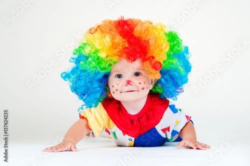 Child clown with a red nose multicolored wig in with balls