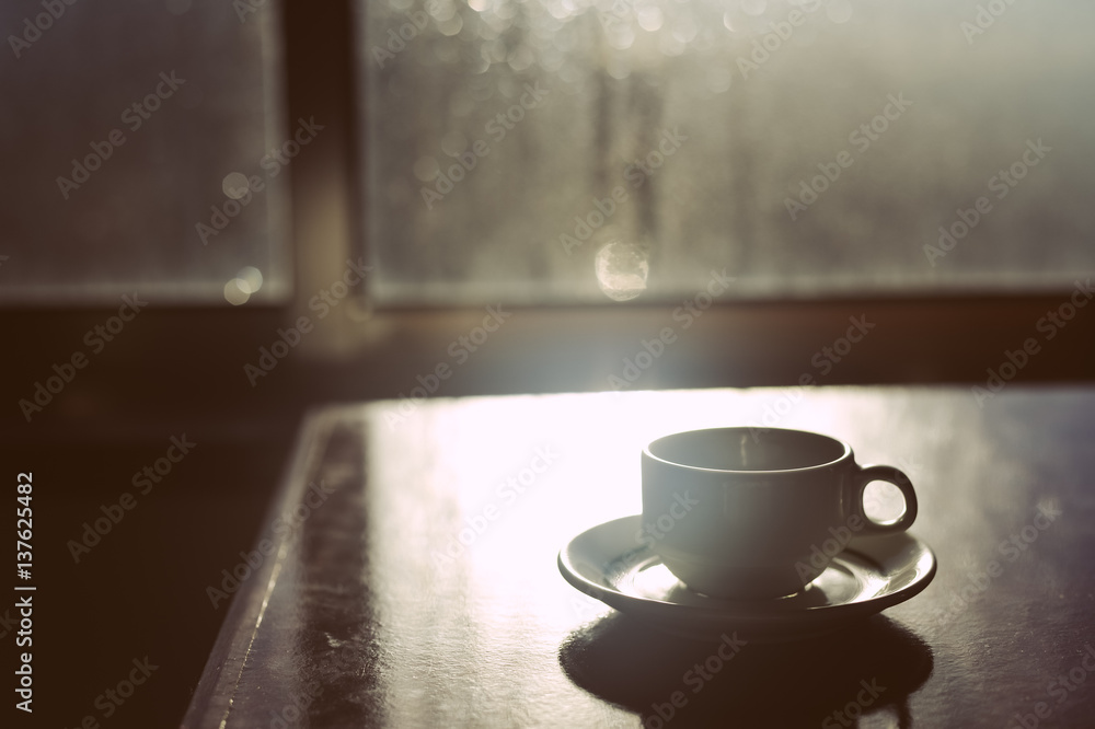 Cup of coffee over misted foggy glass window sill background Cup of coffee over misted foggy glass window sill background