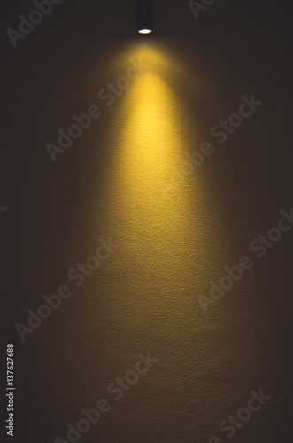 Light on yellow wall background