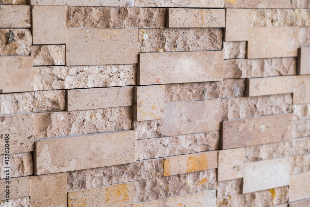 Close up brown modern stone wall background/texture. Close up brown modern stone wall background/texture.