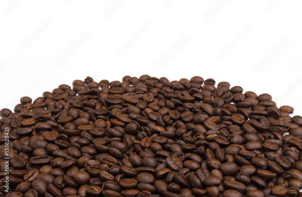 Roasted coffee beans on white. Roasted coffee beans on white.
